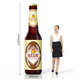 An inflatable beer bottle, featuring brown and gold colours, with a logo and dimensions of 2400mm height.