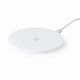 A white wireless charger with a sleek, round design and a connecting cable attached.