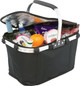 A black picnic cooler bag with a silver handle, filled with drinks, snacks, and an orange, featuring a logo.