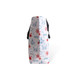 A large polyester cooler tote bag featuring a nautical design in red, blue, and white, with black handles.
