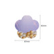 A flower-shaped sticky note in pastel purple with a design of gold and white bubbles at the bottom.