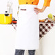 A white polyester canvas half apron with a pocket, featuring a logo, displayed against a kitchen backdrop.