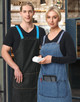 Two models wearing denim aprons with changeable blue and striped straps, featuring pockets for accessories.