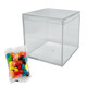 A clear cube container alongside a pack of colourful jelly beans in various shades, including pink, blue, yellow, and green.