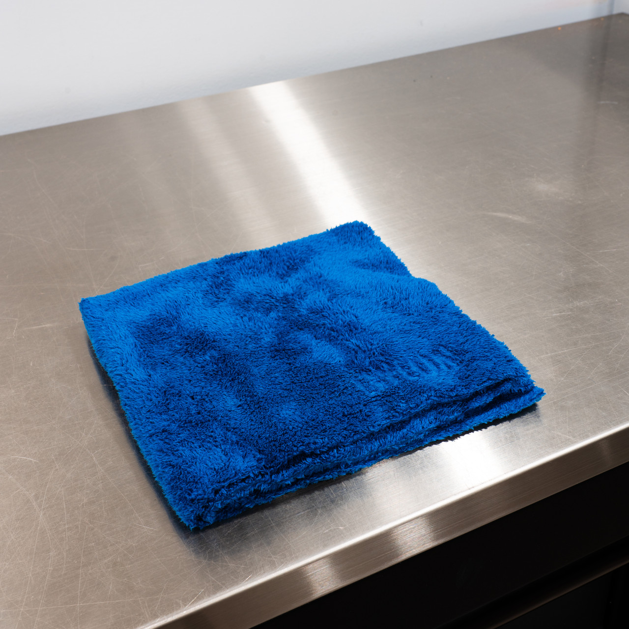 Using a microfiber towel to clean floors instead of the disposable