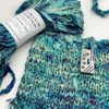 Mermaid's Purse- Use one or two skeins of our hand-dyed Watercolor Sari Ribbon to knit this simple, yet striking bag.  The texture of the ribbon and the sheen of the silk make even simple knitting eye-catching. Free pattern available for download.