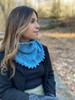 In this cowl, the close-fitting neckline’s comfort is paired impeccably with a faux weave’s texture and elegant flare across the top of the shoulders.