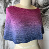 Designed to be worn around the neck as a cowl, or over the shoulders as a capelet; this sweet little garment by Wonderland Yarns can be blocked to be either longer or wider as desired.