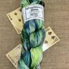 Three of Diamonds, Six of Clubs, & Joker - Mad Hatter Hand-Dyed One-of-a-Kind Yarn from Wonderland Yarns. This sport-weight colorway is a variegation featuring shifting light to dark green and blue tones with a seawater feel.
