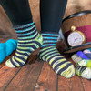 These fun striped socks by Joanna Curley will have you doing a happy dance when you feel how comfortable these are when they hug your feet! Using 5 mini skeins of Queen of Hearts yarn by Wonderland Yarns, these silky soft socks with ribbing detail will be just perfect to add to your collection!