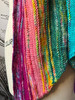 This wrap design is shown using 12 mini skeins of different colorways — but another option features an 8-pack of minis and a 4oz coordinating skein.