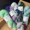 This is an example of how much yarn is included in a Colorburst mystery box! A range of weights, colors, dye styles, and more can be added. Extra mystery goodies not shown.