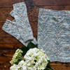 The Trailing Vines Cowl & Mitt pattern set by Wonderland Yarns features and delicate lace pattern that uses simple stitches, allowing both the cowl and mitts to be knit quickly with just one skein.