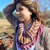 Contrasting colors and chevron stripes create a simple, yet striking infinity scarf. Purl ridges, worked sporadically, add pops of texture in this pattern by Wonderland Yarns. Shown in the Picking Posies + Fall shades kit colorway.