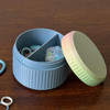 A cheerful divided jar with stitch markers on one side and confetti point protectors tucked neatly on the other. Fluted with opal lid and solid color base, divided into two compartments, “stocked and sorted” contains rainbow ring stitch markers & 2 point protectors. Available in Sprig, Patina , Wisteria, Linen, Chambray, and Thistle—with signature opal screw-top lid.
