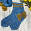 Indulge in cozy comfort with a pair of Twice As Rice socks that incorporate a rice-textured heel and striped cuff in a coordinating pop of color, adding an unexpected element to your everyday attire.