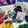 The 2023 yarn advent from Wonderland Yarns included fun surprises like a stitch marker set, felt notion bag, project bag, and felted ornaments!