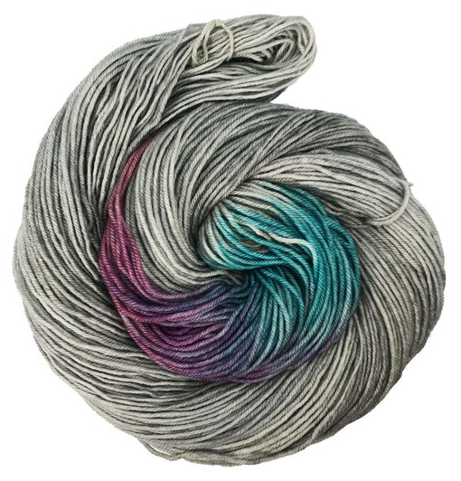 A light greige (grey/beige) background suits the burst of rose pink, plum, and blue with a hint of teal.  Hand dyed by Wonderland Yarns, is available on your choice of yarn base. Made in America.