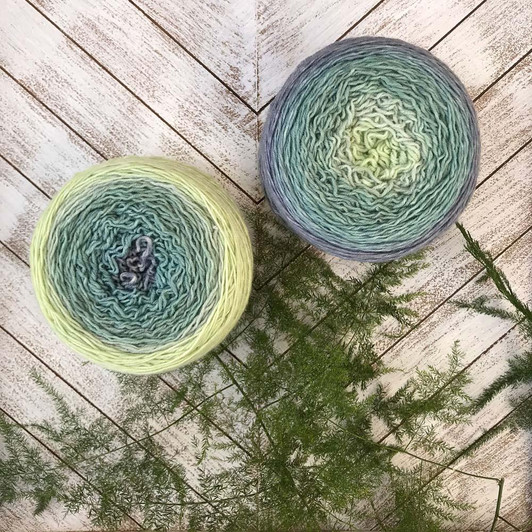 Sage is a muted Blossom gradient cake that starts as a creamy lime green and morphs into sage green, then silvery blue-gray. Hand-dyed by Wonderland Yarns on Mad Hatter sport or sock/fingering weight yarn. Made in Vermont.