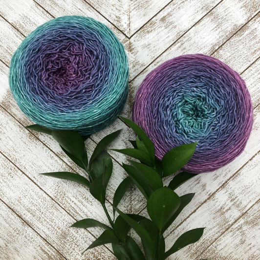 Mertensia is a dark Blossom gradient cake that starts as an aqua-green and morphs into a smoky blue, then purple-pink. Hand-dyed by Wonderland Yarns on Mad Hatter sport or sock/fingering weight yarn. Made in Vermont.
