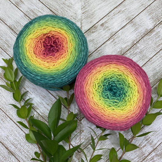 A bold Blossom gradient cake that starts as a bright magenta that morphs into yellow, then emerald. Hand-dyed by Wonderland Yarns on Mad Hatter sport, sock/fingering weight or Lory, DK weight.