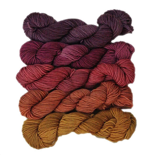 Summer Sunset is a collection of five coordinating mini-skeins in a dark honey brown, rust, red, dark red and dark purple.