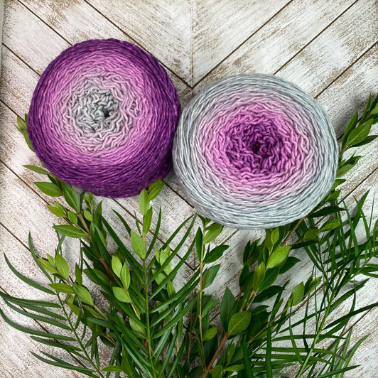 A hand-dyed gradient cake of yarn from Wonderland Yarns that morphs from a rich saturated magenta, into a light grey. The colors magically meld together for a seamless color transformation! For larger projects you can alternate between two or more cakes to create longer color sections. Available in Mary Ann sock/ fingering weight, Mad Hatter sport weight 4oz or Lory DK.