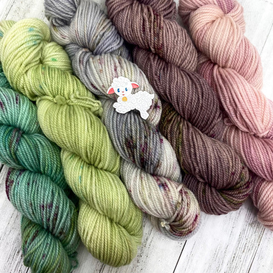 "Lamb" is a light, springy mini skein pack, featuring blushing pinks, rich greens, and layered greys. From our past Kitsch club, this kit includes a free pattern and the enamel pin pictured.