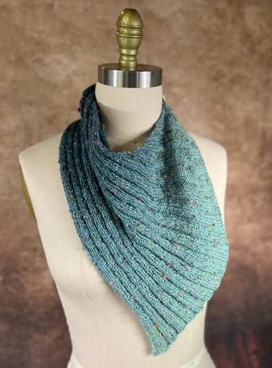 Knit in a classic knit three-purl three ribbing, this bandana shaped cowl is one of those projects that becomes a staple of your knitted wardrobe.