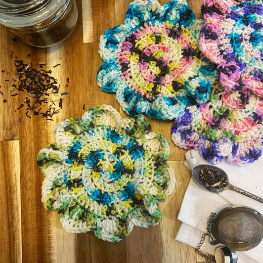 Three different mini colors combine in a swirl to create a perfect meld of chaos for these fun crochet coasters by Paige Scudder.
