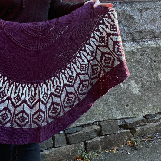 Shaped by the magic of half pi construction, the colorwork of this DK-weight shawl conjures the soaring lines of gothic cathedrals and shadowed archways.