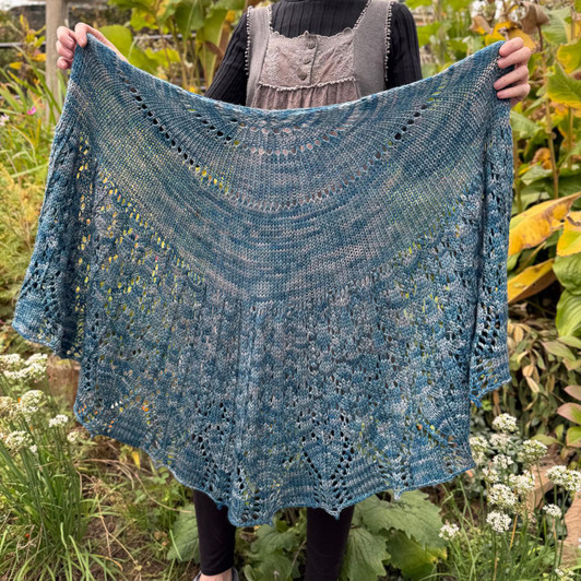 Built on the classic half-pi framework, the Sotherton Garden Shawl combines simple and magical shaping with engaging lace stitches. The DK weight yarn creates a shawl that’s both substantial and elegant, perfect for wrapping up in comfort and style.