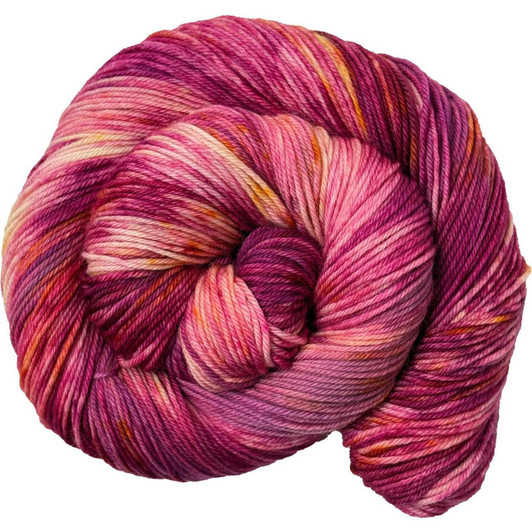 A variegated colorway featuring layers of pink and magenta, speckled with orange