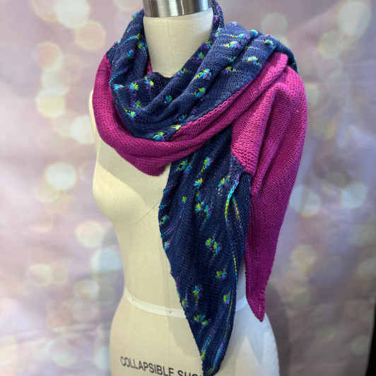 Pooling Party is a playful, asymmetric shawl designed to celebrate color, contrast, and a little bit of knitting mischief. Shaped with central decreases that form a bold arrow —pointed at one end and V at the other!
