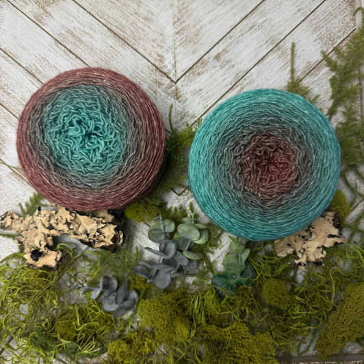 Blue Star Fern is a hand-dyed gradient cake of yarn from Wonderland Yarns that transitions from a sepia brown to teal