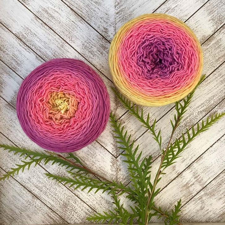 Dahlia is a Blossom gradient cake that starts as fuchsia pink and morphs into watermelon, then sunshine yellow. Hand-dyed by Wonderland Yarns on Mad Hatter sport or sock/fingering weight yarn. Made in Vermont.