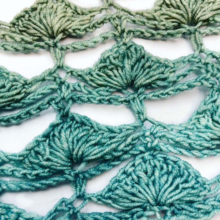 Seacoast Cowl-Blossoms yarn is dyed with washes of color, each building on another, blending and shifting to form a seamless morph of color. This crocheted cowl shows the watercolor washed colors to their advantage, the repeats of the crochet lace highlighting the color changes.