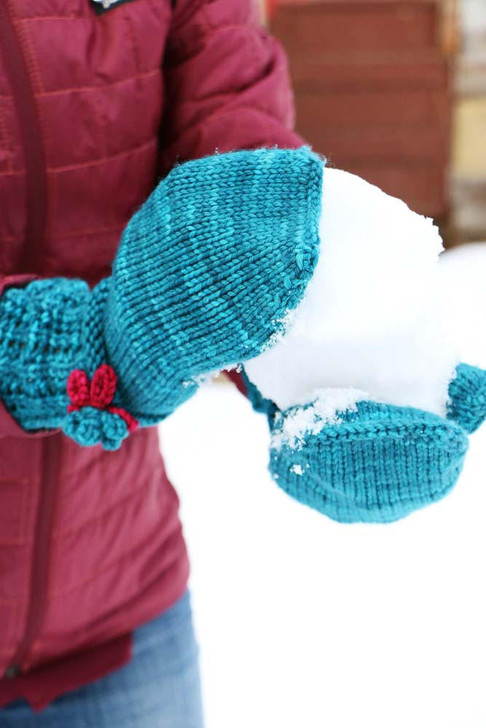 Storybook Mittens- These whimsical mittens feature a lace cuff and contrasting color crochet flowers. Free pattern available for download.