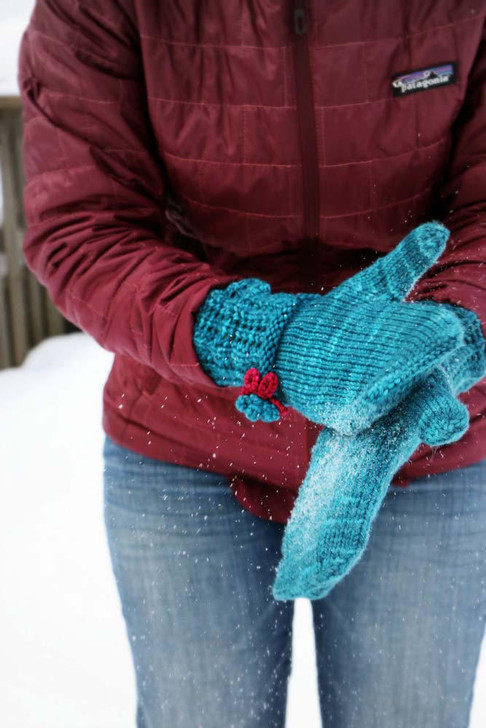 Storybook Mittens- These whimsical mittens feature a lace cuff and contrasting color crochet flowers. Free pattern available for download.