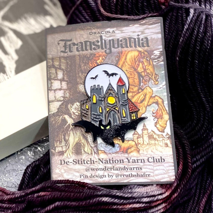 Wonderland Yarns deSTITCHnation literary realms custom-designed and glow-in-the-dark enamel pin for Transylvania.