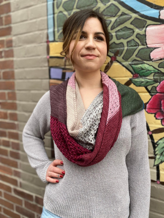 This generously sized scarf is worked on the bias in eight colors — alternating between sections of a simple lace and stockinette. Perfect for working up in an 8-pack of minis or with two coordinating colorways.