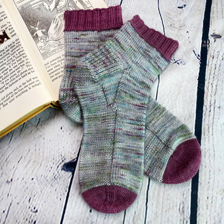 Grab your favorite sock knitting needles and hop on the comfort train! Using reverse stockinette on the bottom of the foot means the flat (not bumpy) part of the fabric is touching your sole, making these socks lovely to wear in shoes and around the house.
