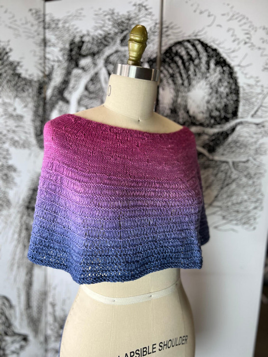 Designed to be worn around the neck as a cowl, or over the shoulders as a capelet; this sweet little garment by Wonderland Yarns can be blocked to be either longer or wider as desired.