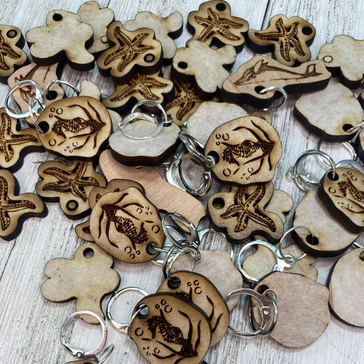 We're a big fan of cute charms and beads... so our stitch marker collection is overflowing with lots of fun for your projects ahead! There are wood (designed by us in the studio!) and metal, and some beads too!