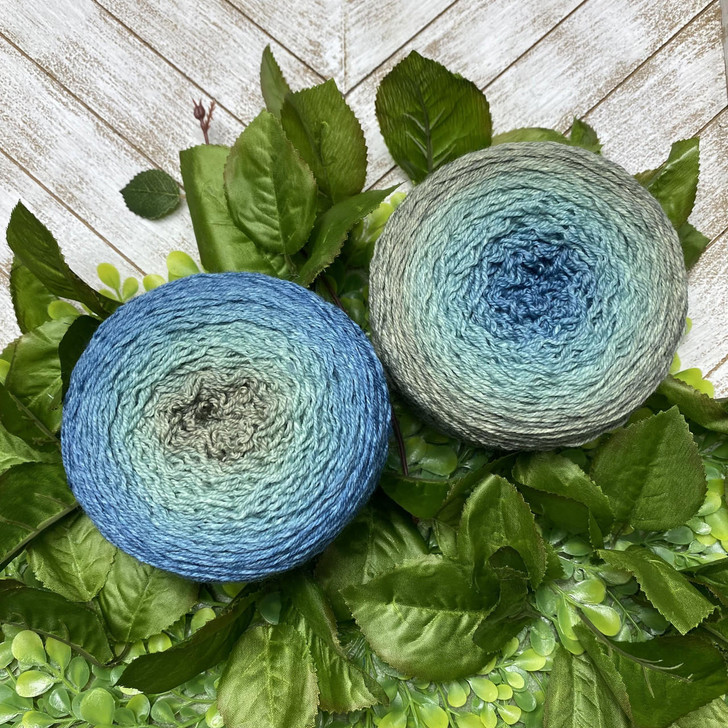 A hand-dyed gradient cake of yarn from Wonderland Yarns. This cake morphs from a silvery-sage green, to a seafoam green, then into a rich blue. The colors magically meld together for a seamless color transformation!