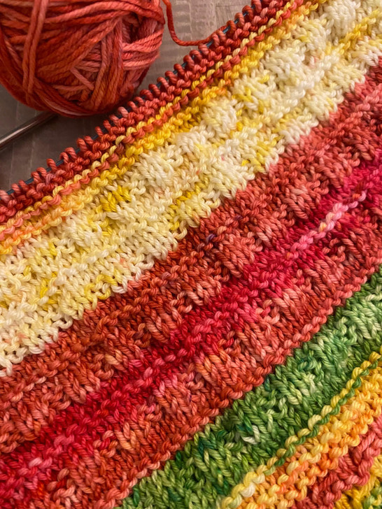 The 2022 Whatever the Weather blanket features Wonderland Yarns Luminous Collection handdyed colorways. These colorways are still available for purchase.