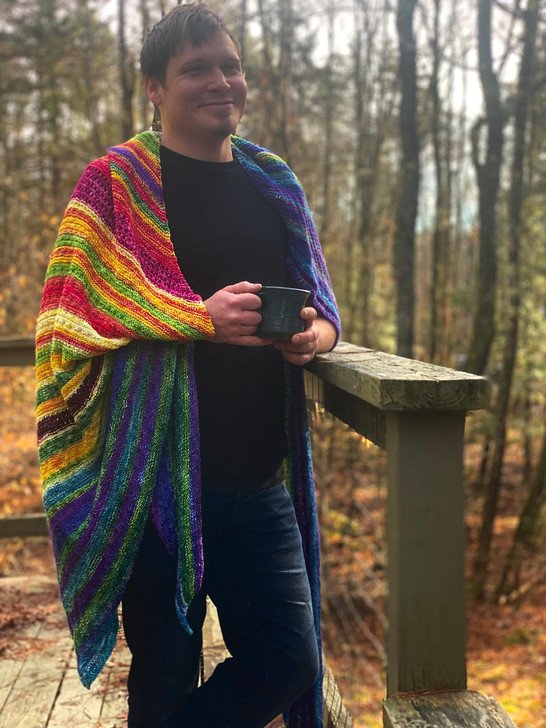The 2022 Whatever the Weather blanket featuring Wonderland Yarns Luminous Collection handdyed colorways is a super cozy blanket that can easily be draped on a couch or snuggled into on chilly mornings.