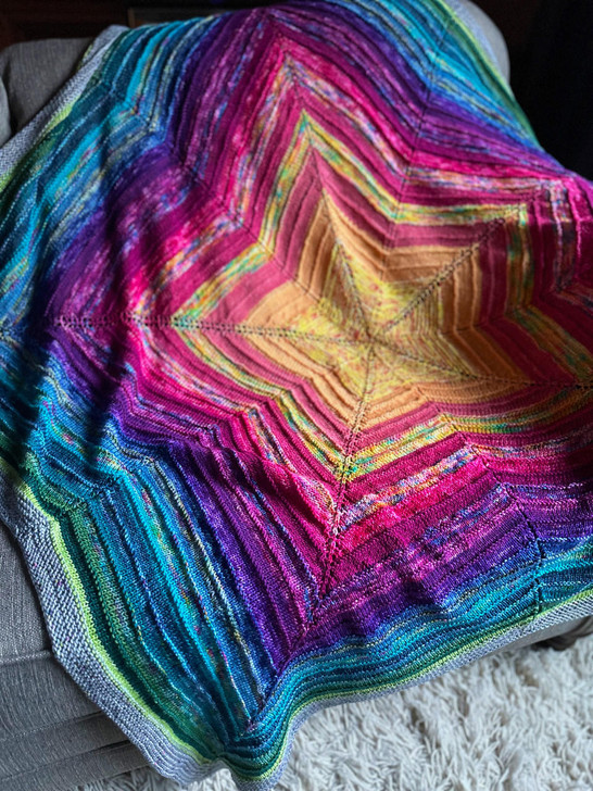 Knit from the center-out, simple increases and decreases create the shape of this colorful blanket.