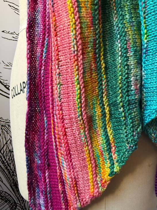 This wrap design is shown using 12 mini skeins of different colorways — but another option features an 8-pack of minis and a 4oz coordinating skein.