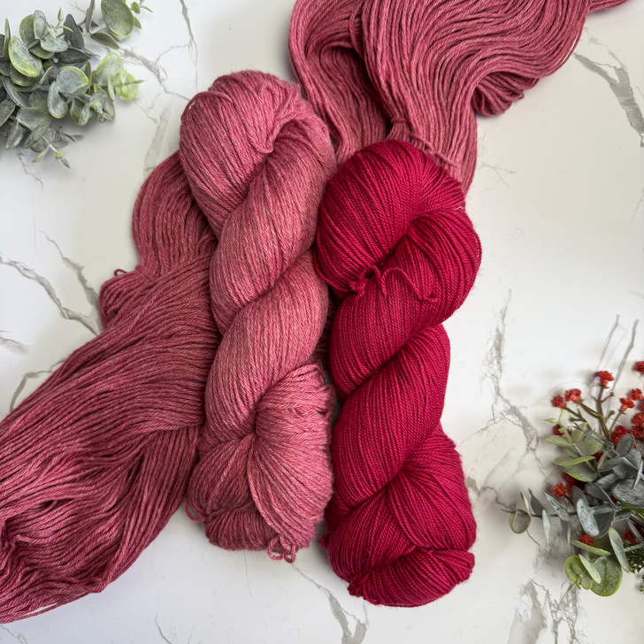 A comparison of Cotton Kiss and Mary Ann sock/fingering on the colorway 'Off with Her Red!'